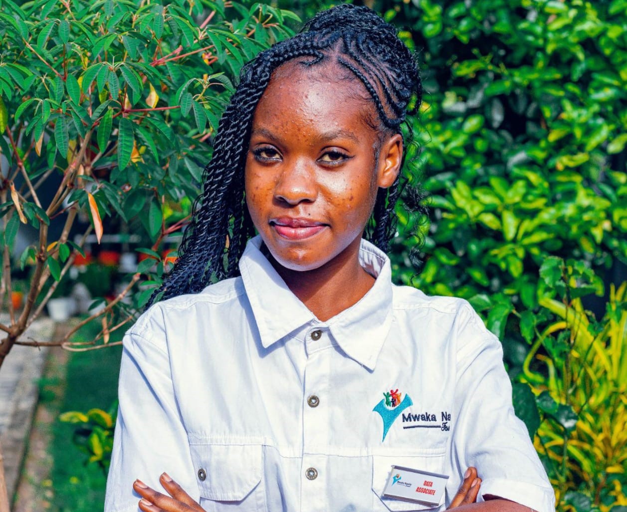 Young Zambian woman smiling confidently outdoors